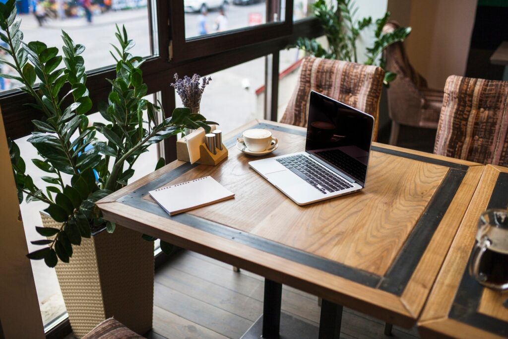 coworking space with wooden table and laptop